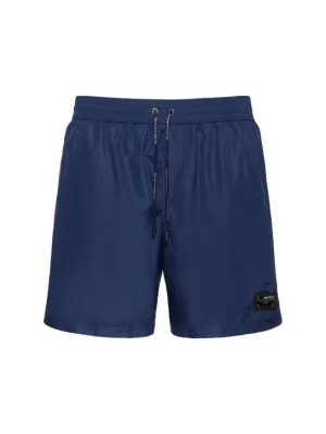 Dolce&amp;Gabbana   Solid color swim shorts w/ logo plaque 