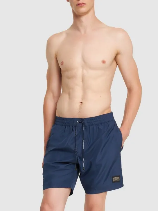 Dolce&amp;Gabbana   Solid color swim shorts w/ logo plaque 